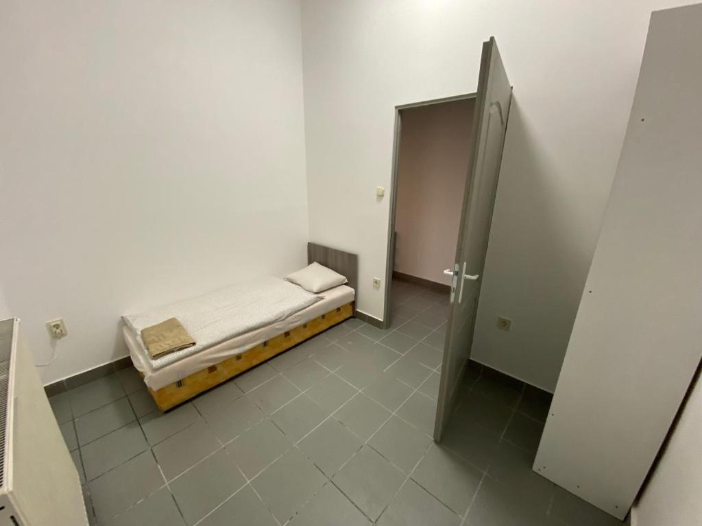 Postel nebo postele na pokoji v ubytování Tocc Apartman