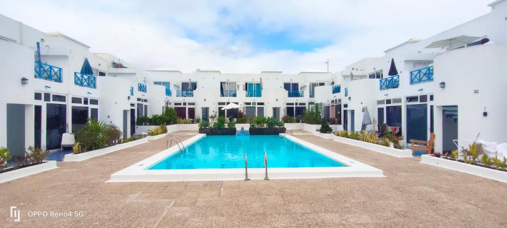 a swimming pool in the courtyard of a building at RED in Puerto del Carmen