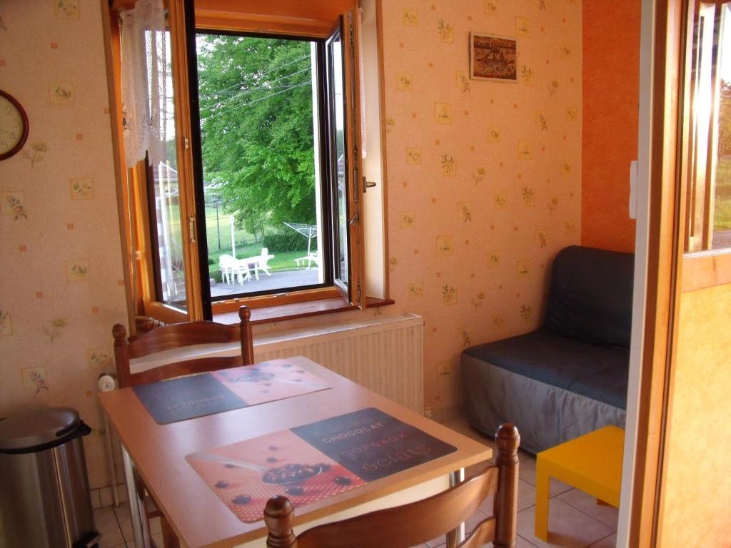a small room with a table and a window at Gîte Les Hirondelles in Plombières-les-Bains
