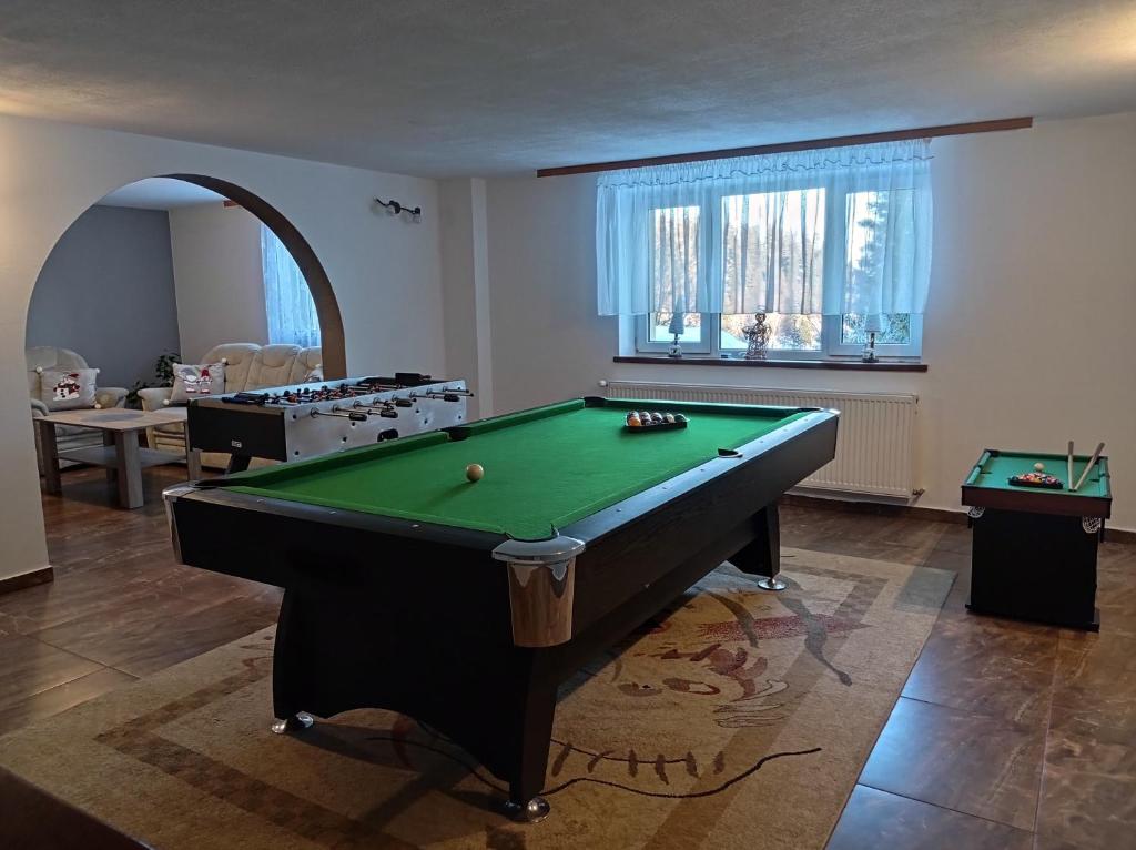 a living room with a pool table in it at Nad Lasem in Bukowina Tatrzańska