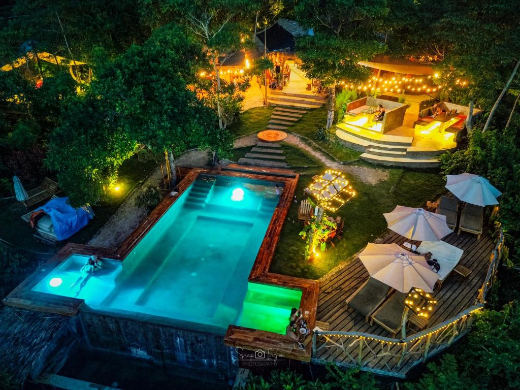 an overhead view of a swimming pool at night at Nakabalo Guesthouse & Restaurant in Siquijor