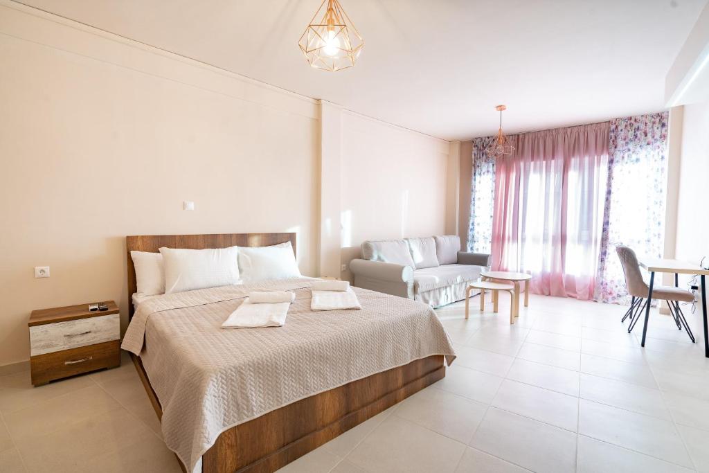 a bedroom with a bed and a living room at Monastiraki metro station studio for 4 persons in Athens