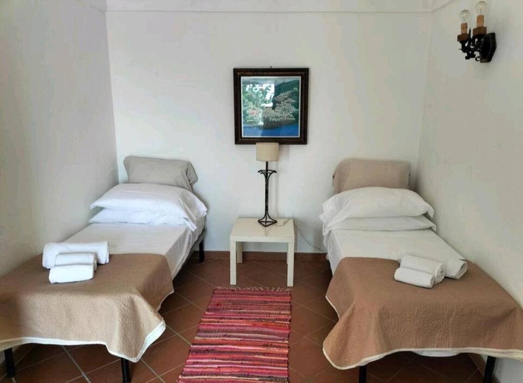 A bed or beds in a room at Villino Prota, villa ridente con panorama mozzafiato