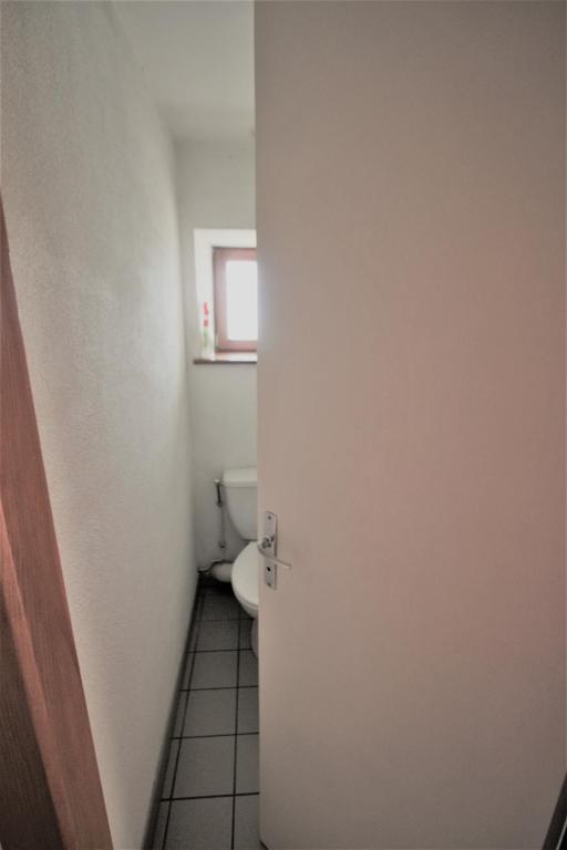 an open door to a bathroom with a toilet at Gîte Les Hirondelles in Plombières-les-Bains