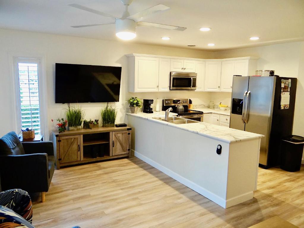 a kitchen with a refrigerator and a counter top at 17A GCR Lovely 2 bed Condo with pool in Surfside in Myrtle Beach