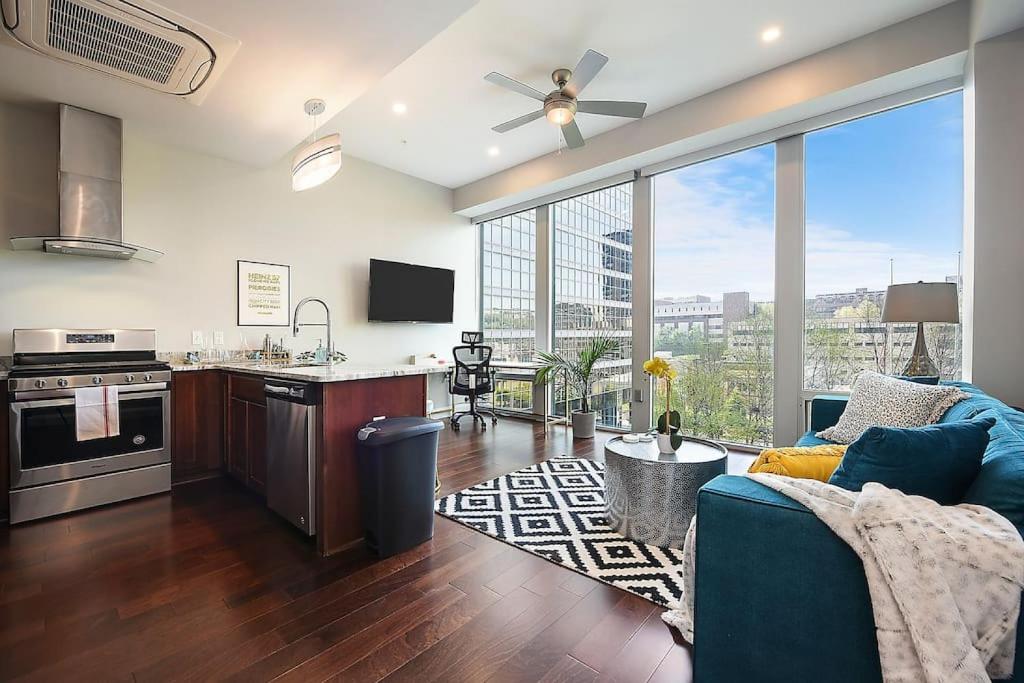 a kitchen and living room with a large window at HostWise Stays - The Washington at Chatham - Free Parking, Great Views, Across from PPG Arena in Pittsburgh
