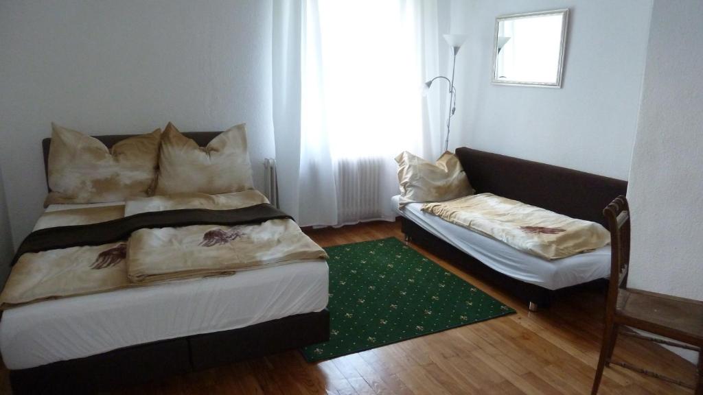 a bedroom with a bed and a couch at Lemmerer Homestay in Sankt Lorenzen bei Knittelfeld