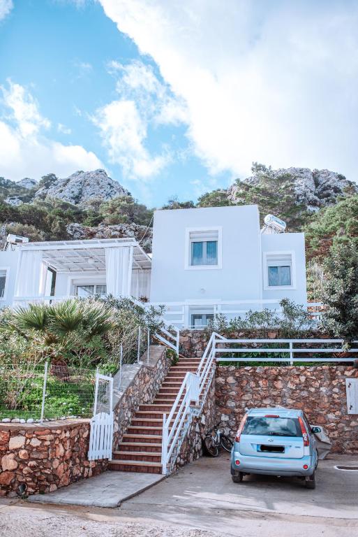 a car parked in front of a house at Villa Sea Breeze in Karpathos