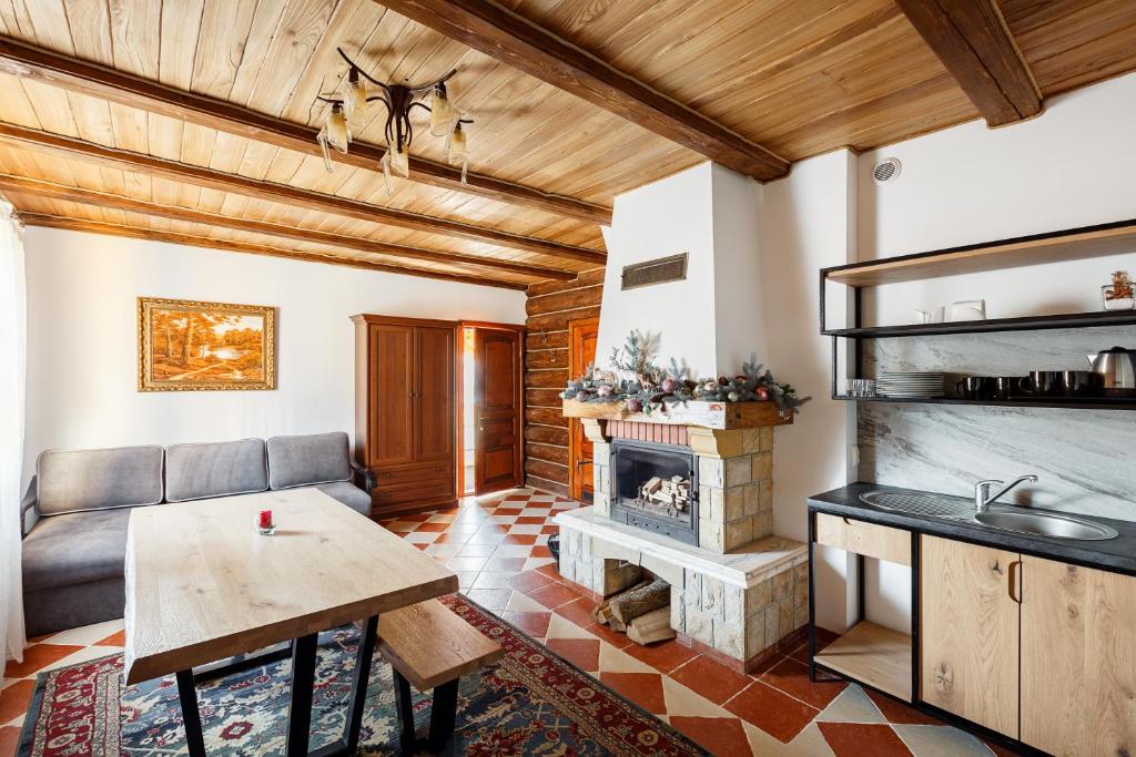 a living room with a couch and a fireplace at Korona Hotel&SPA in Bukovel