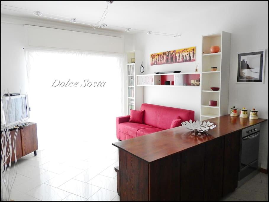 a living room with a red couch and a red chair at Dolce Sosta in Ceriale