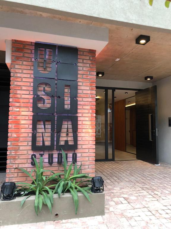 a brick building with a sign on the side of it at Usina Studio by FMA Coliving in Salta