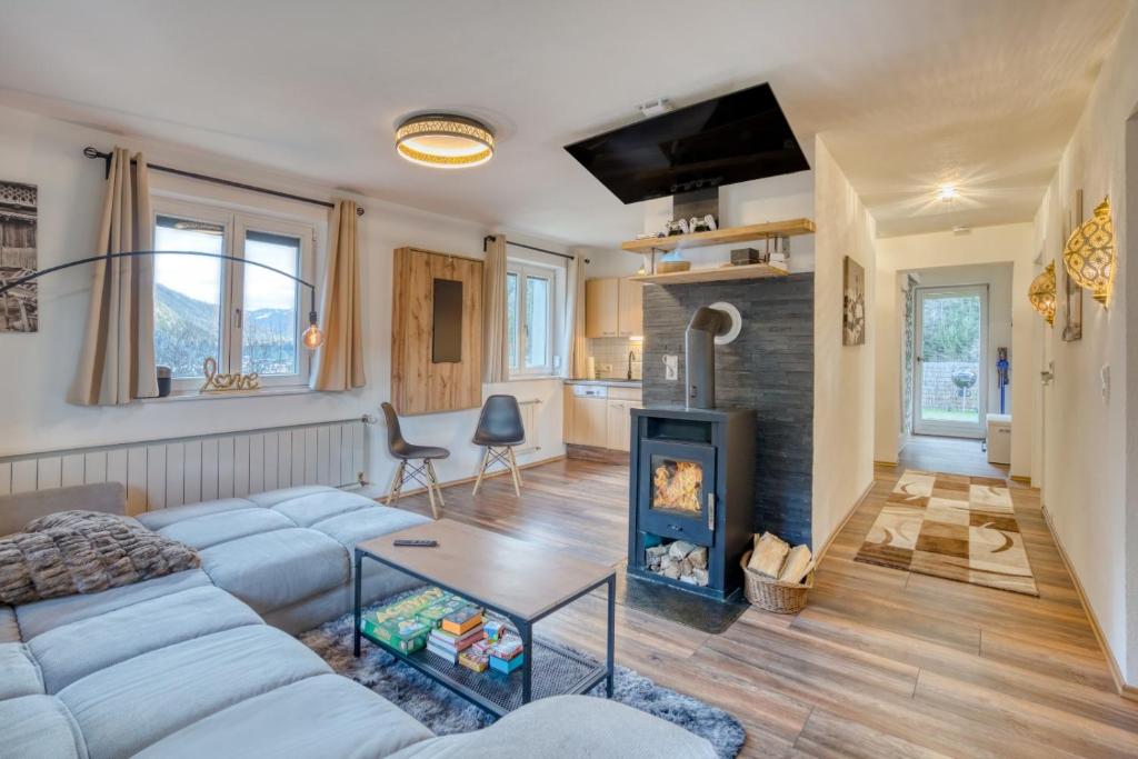 a living room with a couch and a fireplace at Sweet Home Apartments in Tösens