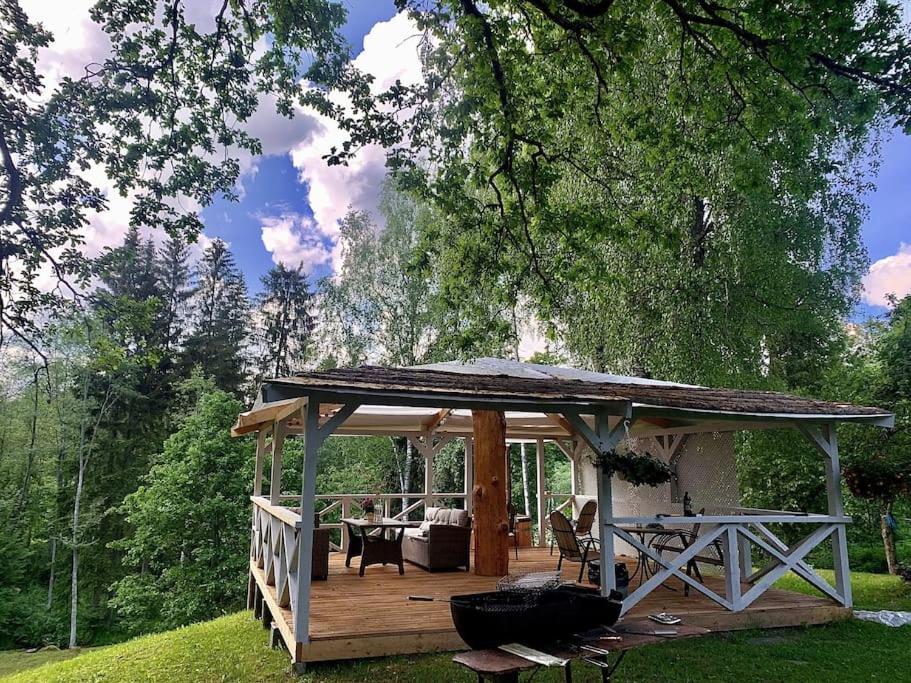 a wooden gazebo in a yard with a table at Vana-Vastseliina külalistemaja in Illi