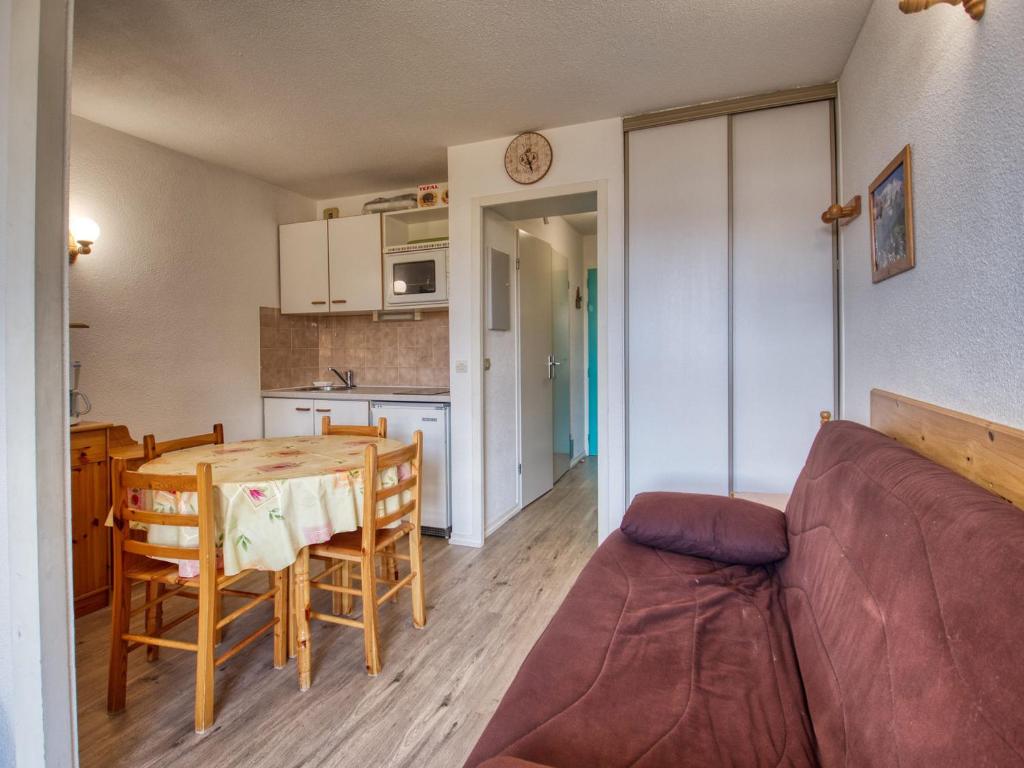 a living room and kitchen with a table and a couch at Appartement Morillon 1100, 2 pièces, 5 personnes - FR-1-642-31 in Morillon