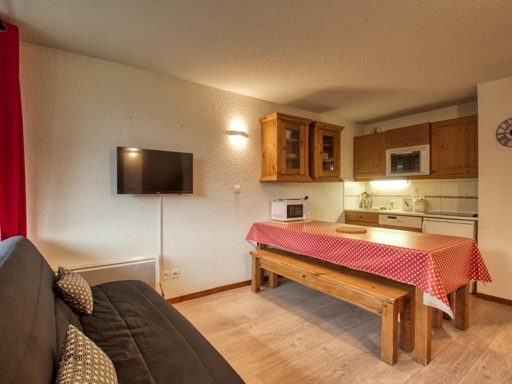 a kitchen with a table with a red table cloth on it at Appartement Morillon 1100, 3 pièces, 6 personnes - FR-1-642-15 in Morillon