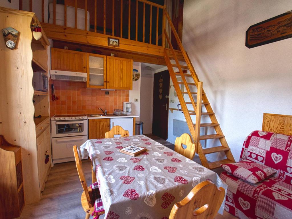 a small kitchen with a table and a staircase at Appartement Morillon Village, 2 pièces, 4 personnes - FR-1-642-38 in Morillon