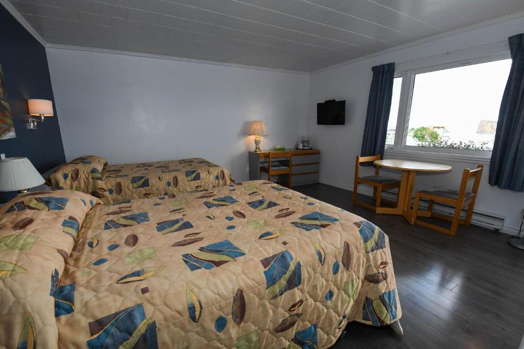 Postel nebo postele na pokoji v ubytování Motel Nouvel Horizon