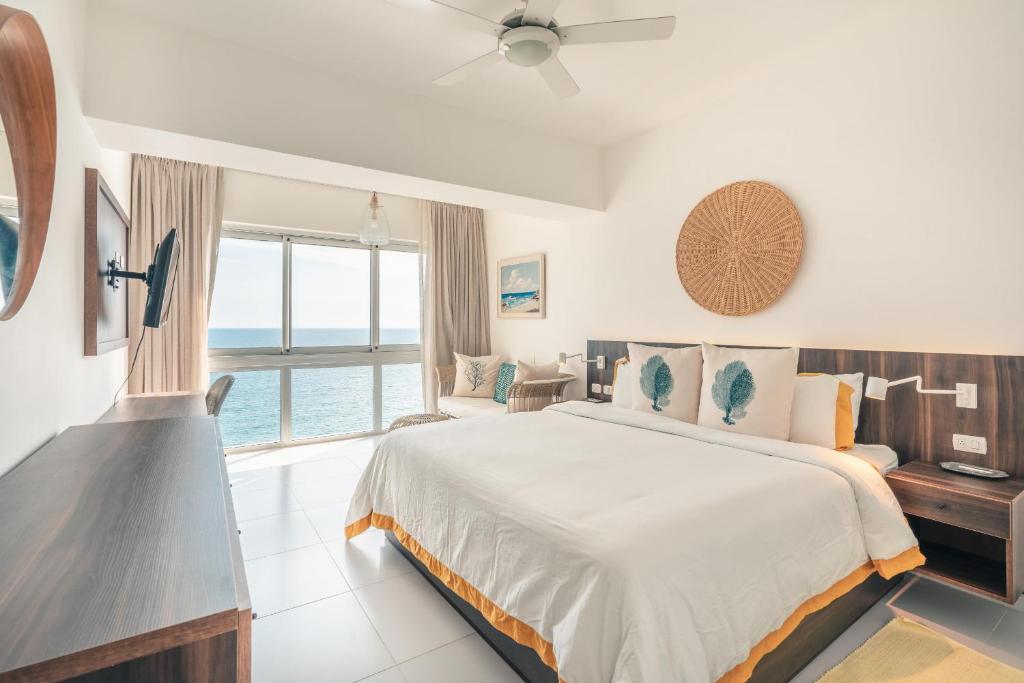 a bedroom with a bed and a view of the ocean at 2BR Apartment at Aquarella AG02 in Juan Dolio