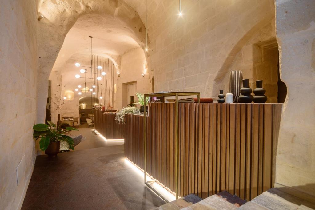 a lobby with a wooden partition in a building at Le Malve Cave Retreat in Matera