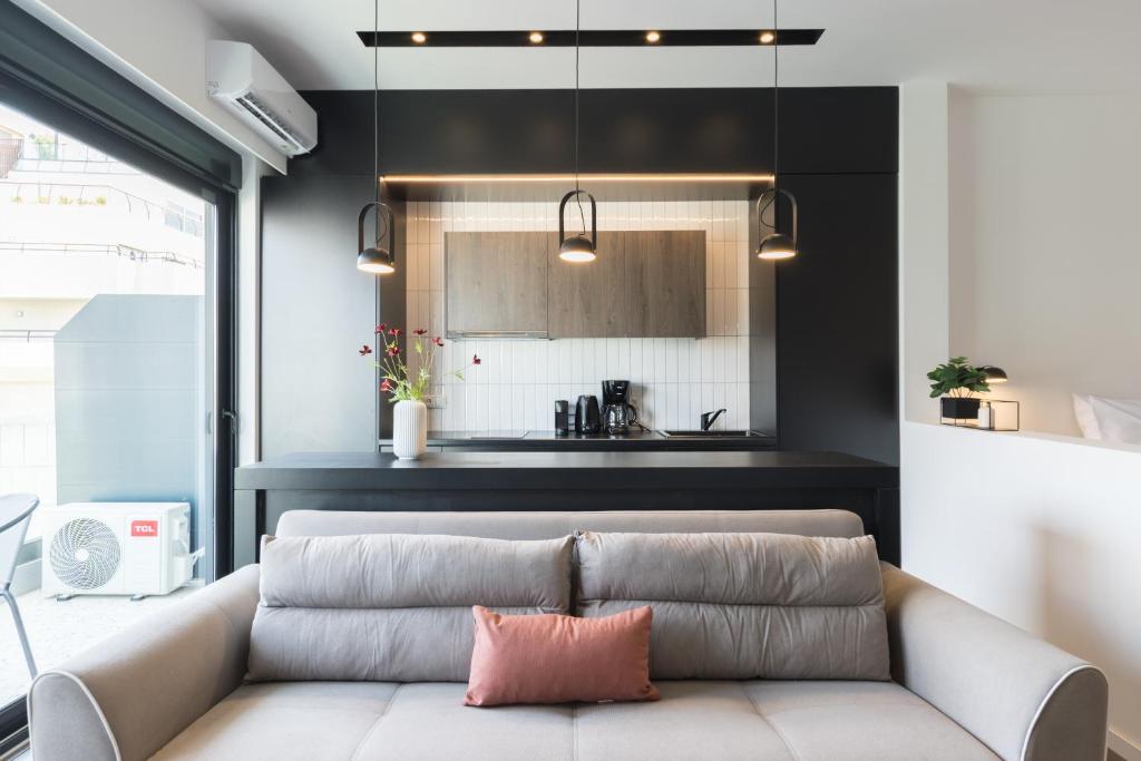 a living room with a couch and a kitchen at Voda Luxury Residence #501 in Athens