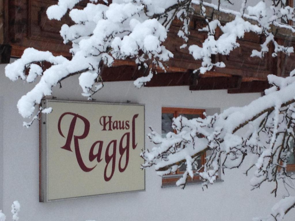 a sign that reads knows ragazi is covered in snow at Haus Raggl in Landeck