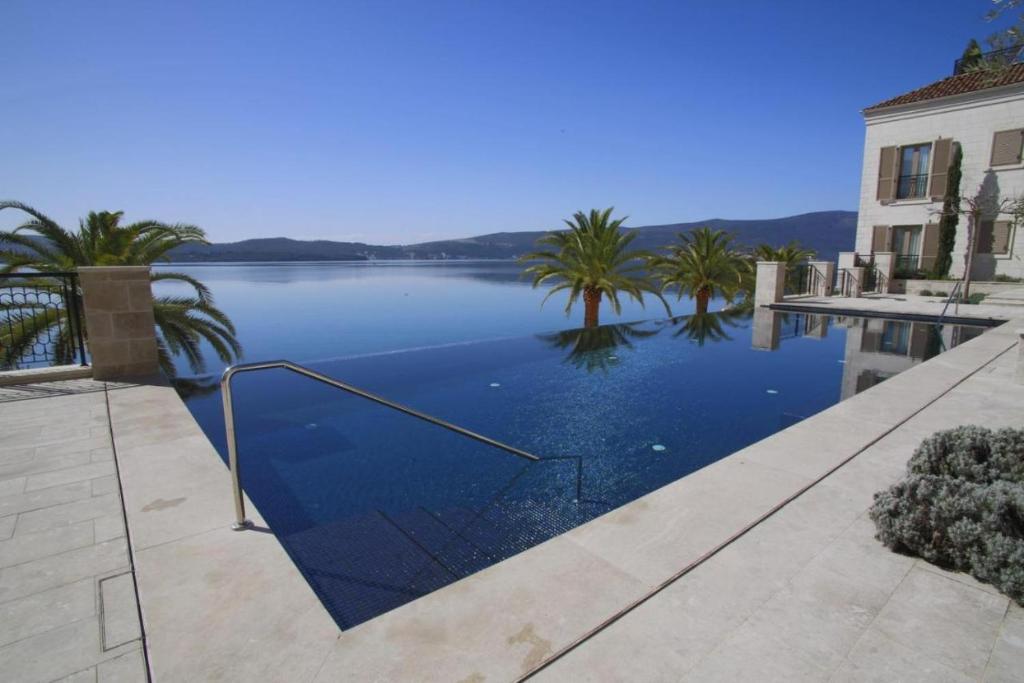 a swimming pool with a view of a lake at Porto Montenegro in Tivat