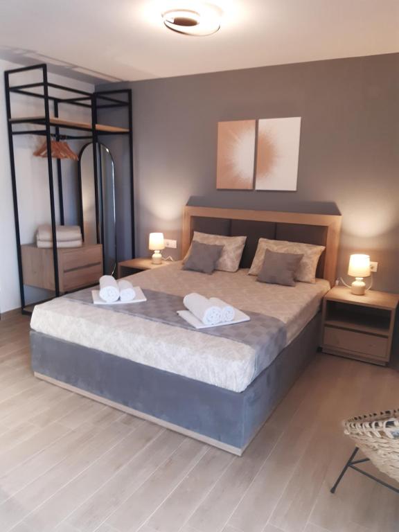 a bedroom with a large bed with two towels on it at Studio Wilem in Sarti