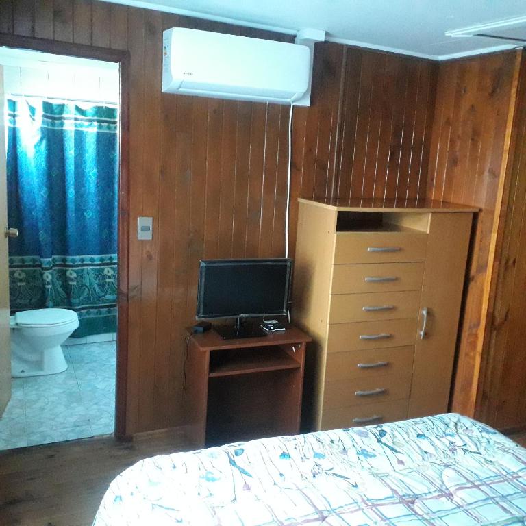 Postel nebo postele na pokoji v ubytování Hostal Rayen