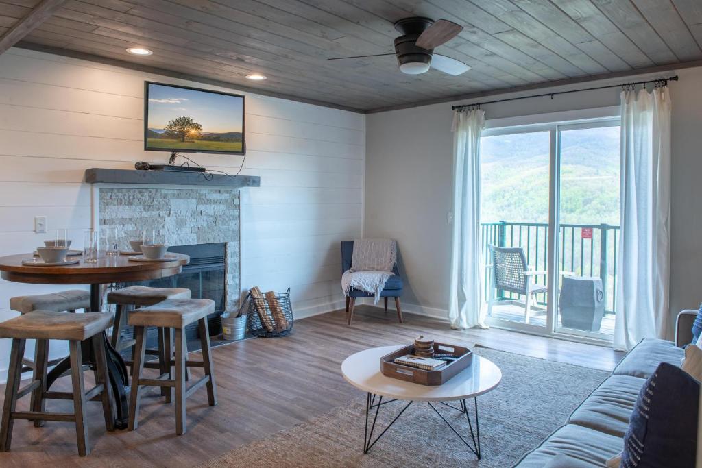 a living room with a couch and a fireplace at Modern Mountain Escape in Gatlinburg