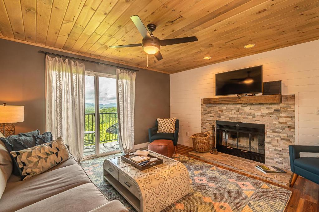 a living room with a couch and a fireplace at Serenity Bliss in Gatlinburg