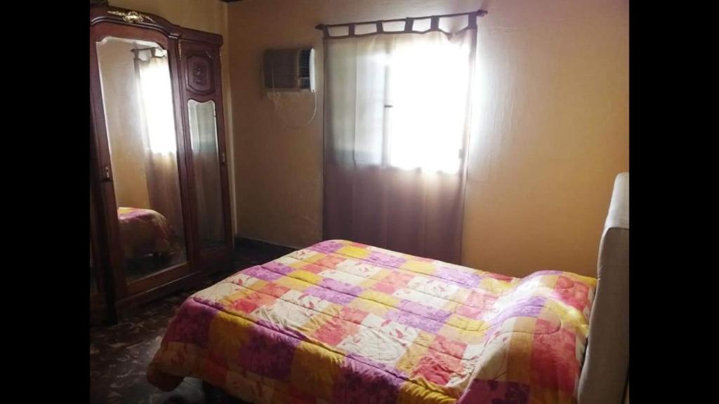 1 dormitorio con 1 cama, vestidor y ventana en Chacra Lo de Chicharra en Gualeguay