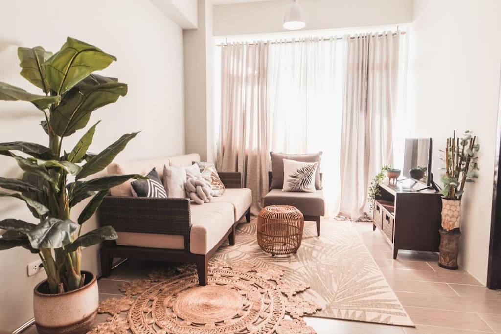 a living room with a couch and a chair at Modern Tropical Luxe Apartment - Ilig-Iligan Beach in Boracay