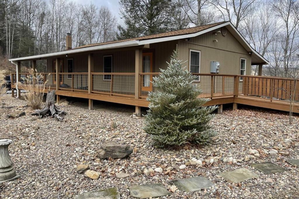 a house with a christmas tree in front of it at The Retreat by On Cue Properties 