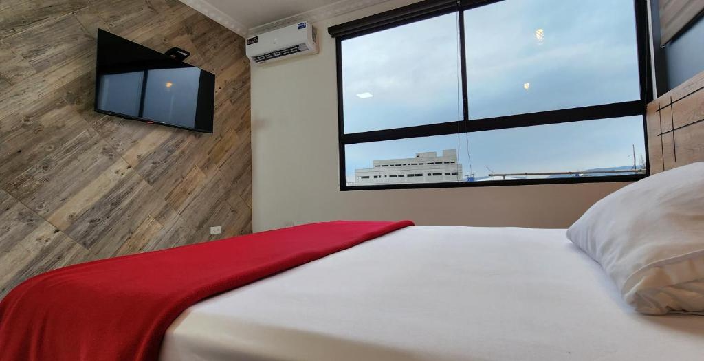 Postel nebo postele na pokoji v ubytování Hotel Murali - Cerca del Aeropuerto de Guayaquil