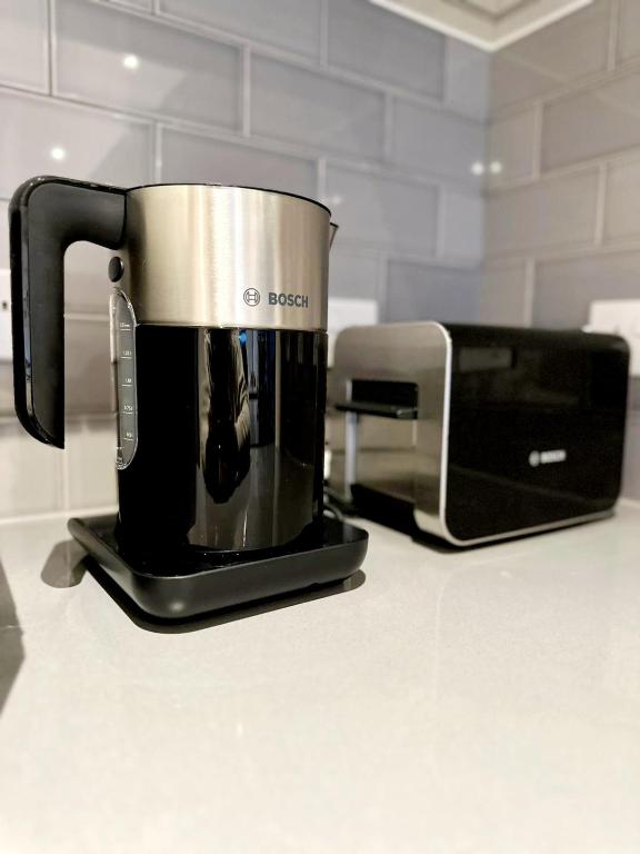 a coffee maker sitting on a counter next to a toaster at Stunning 1 Bedroom Apartment in London