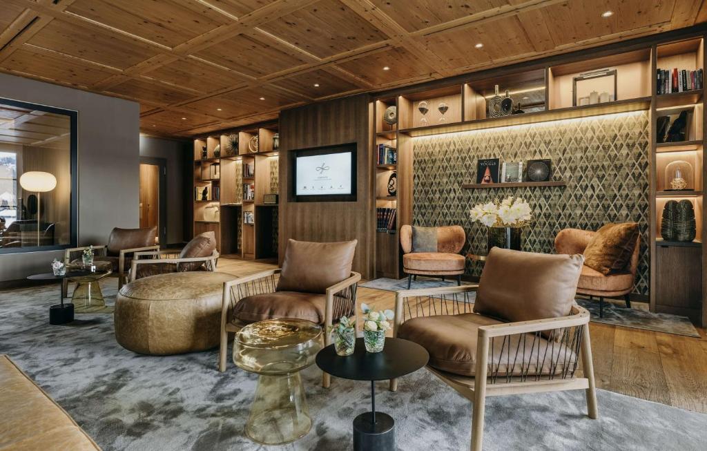 a salon with chairs and a tv in a room at Grand Tirolia Kitzbühel - Member of Hommage Luxury Hotels Collection in Kitzbühel