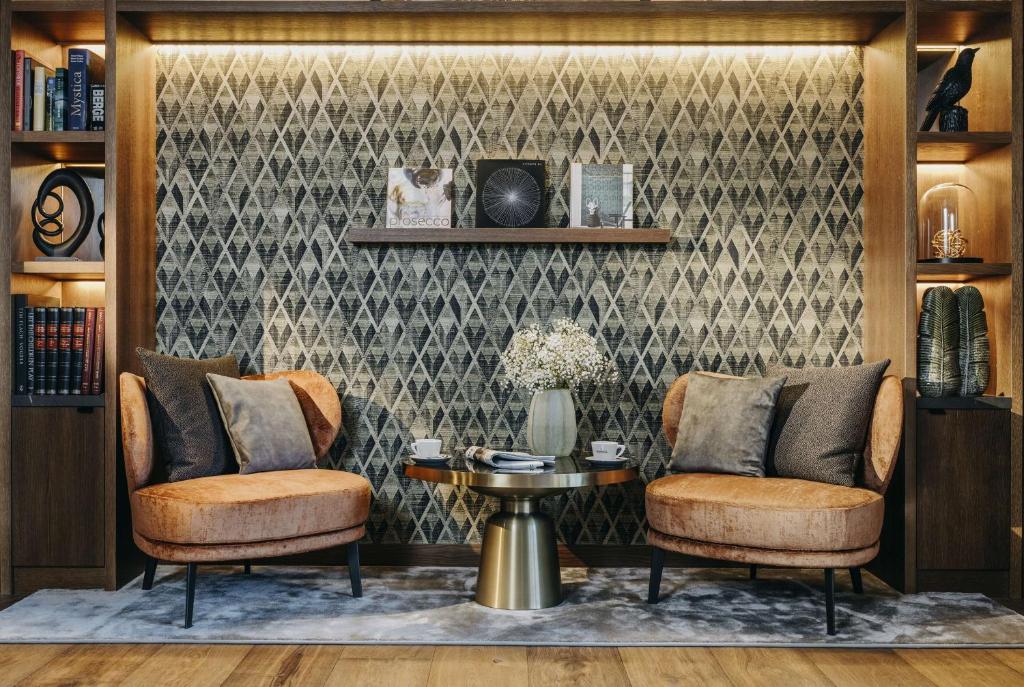 a living room with two chairs and a table at Grand Tirolia Kitzbühel - Member of Hommage Luxury Hotels Collection in Kitzbühel