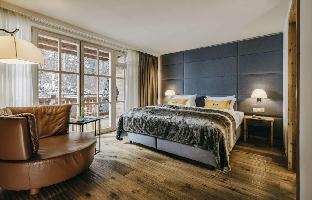 a hotel room with a bed and a chair at Grand Tirolia Kitzbühel - Member of Hommage Luxury Hotels Collection in Kitzbühel