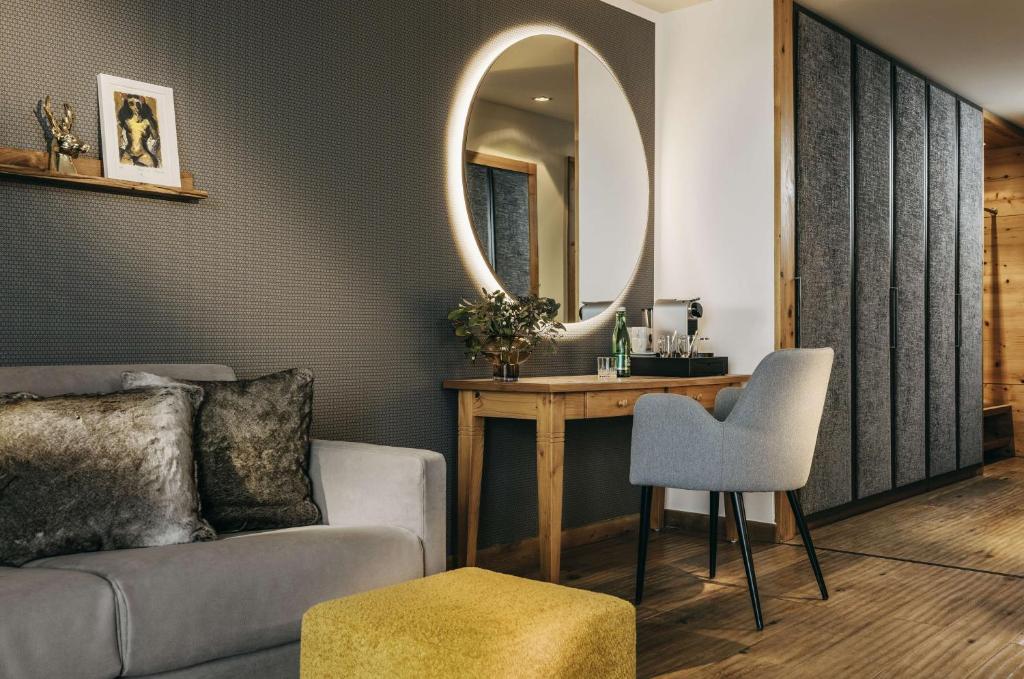 a living room with a couch and a mirror at Grand Tirolia Kitzbühel - Member of Hommage Luxury Hotels Collection in Kitzbühel