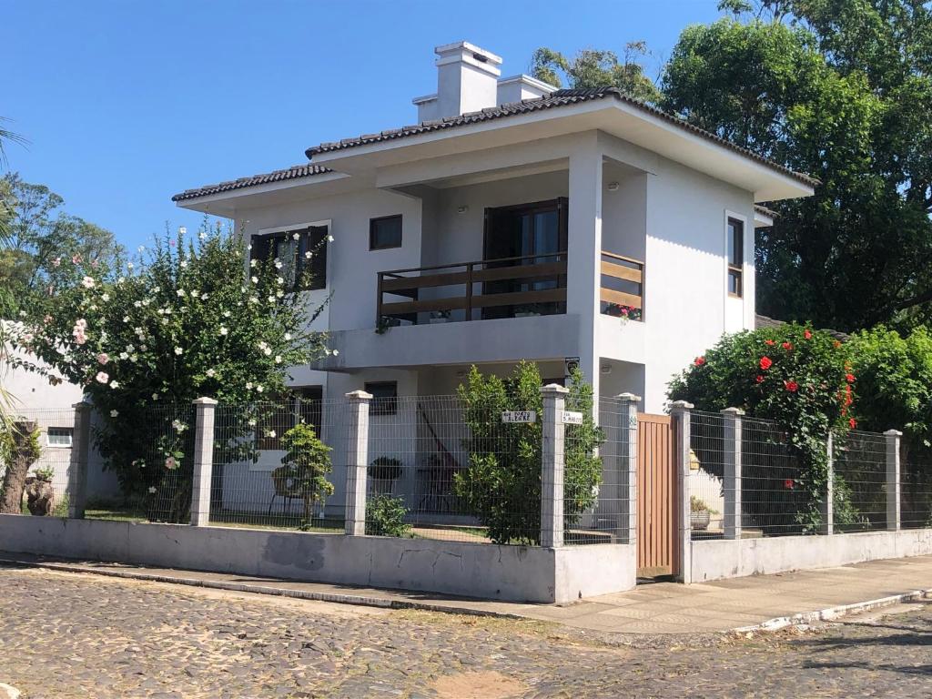 una casa blanca con una valla delante en Sobrado aconchegante, en Torres