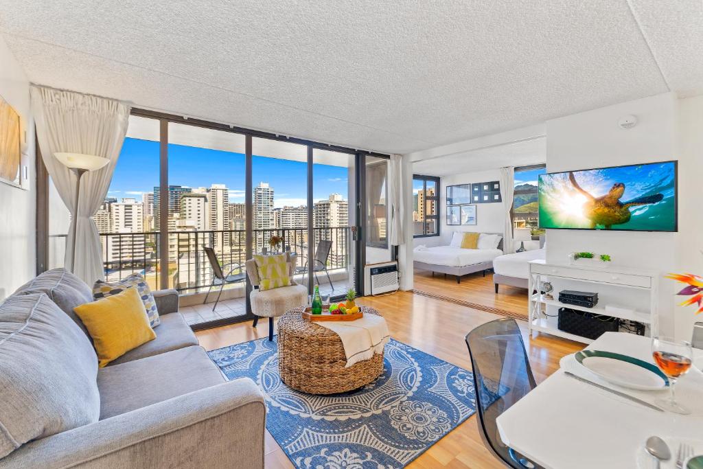 a living room with a couch and a tv at Aloha Getaway, Ocean View Condo Near Waikiki Beach with Free Parking in Honolulu