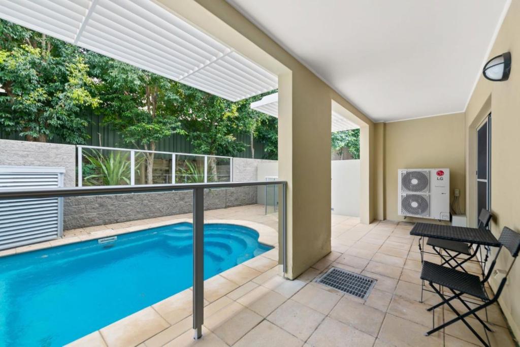 a swimming pool in a house with a balcony at Pacific Blue 520 private pool air conditioning and Wi Fi in Salamander Bay