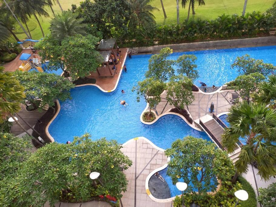 an overhead view of a swimming pool at a resort at The Mansion Kemayoran, lovely 3 bed apartment. in Jakarta