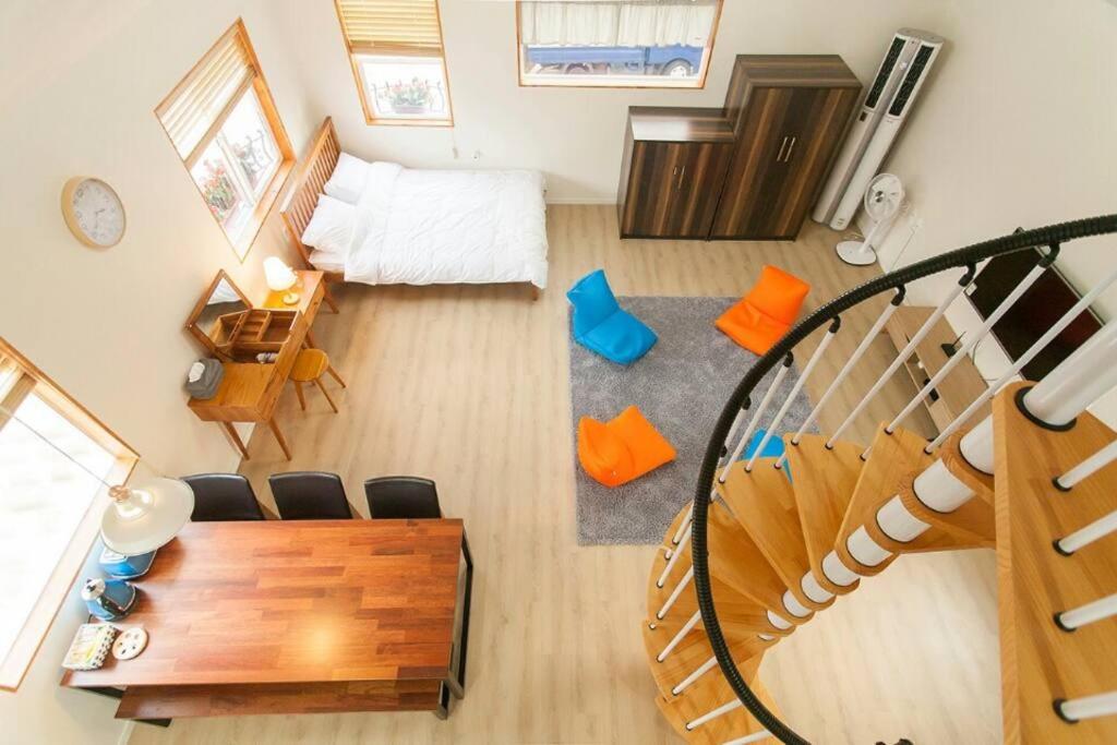 an overhead view of a living room with a spiral staircase at Bandi House in Seogwipo