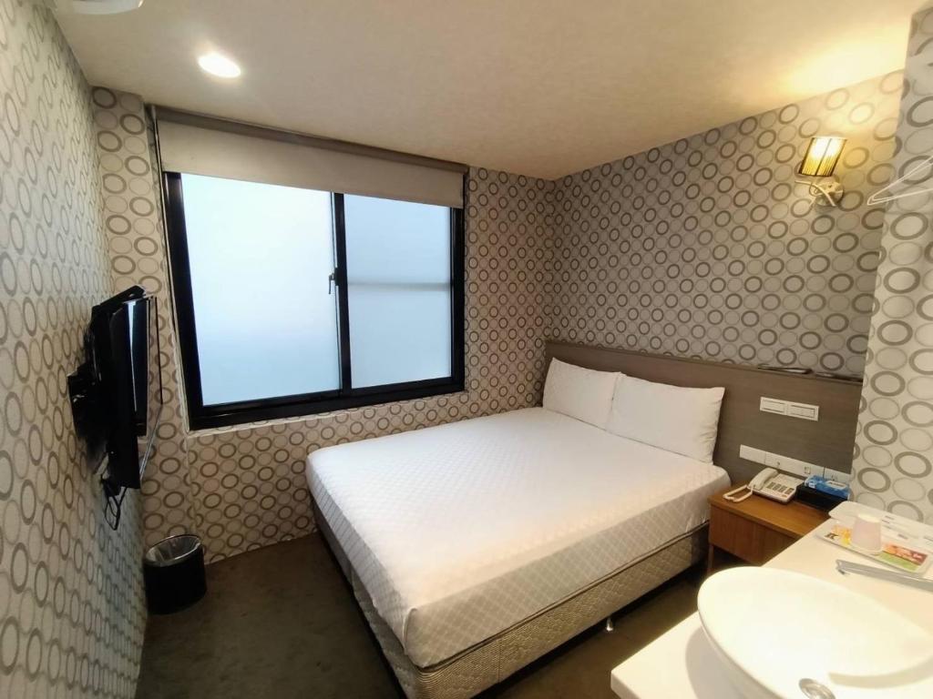Postel nebo postele na pokoji v ubytování Taiwan Seven Days Boutique Hotel