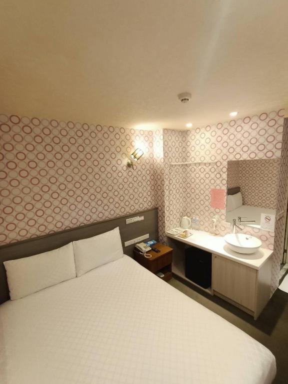 Postel nebo postele na pokoji v ubytování Taiwan Seven Days Boutique Hotel
