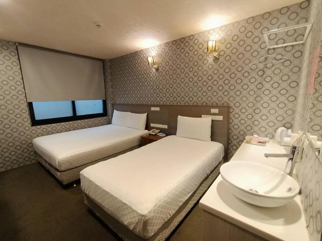 Postel nebo postele na pokoji v ubytování Taiwan Seven Days Boutique Hotel