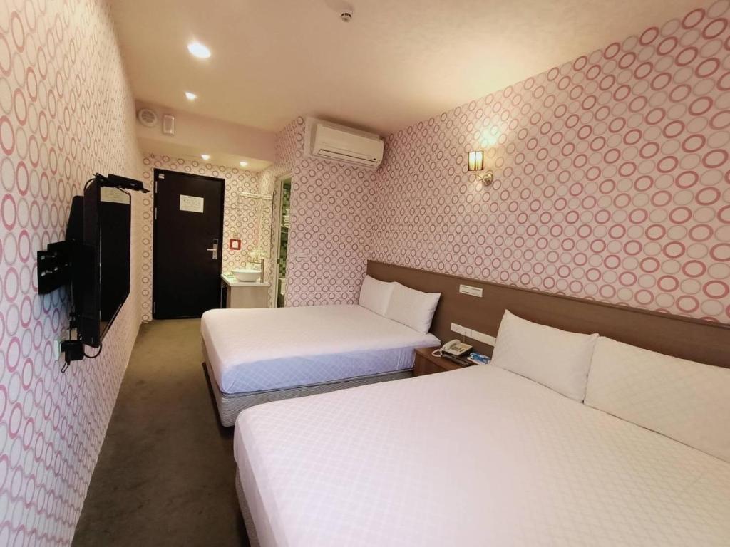 Postel nebo postele na pokoji v ubytování Taiwan Seven Days Boutique Hotel