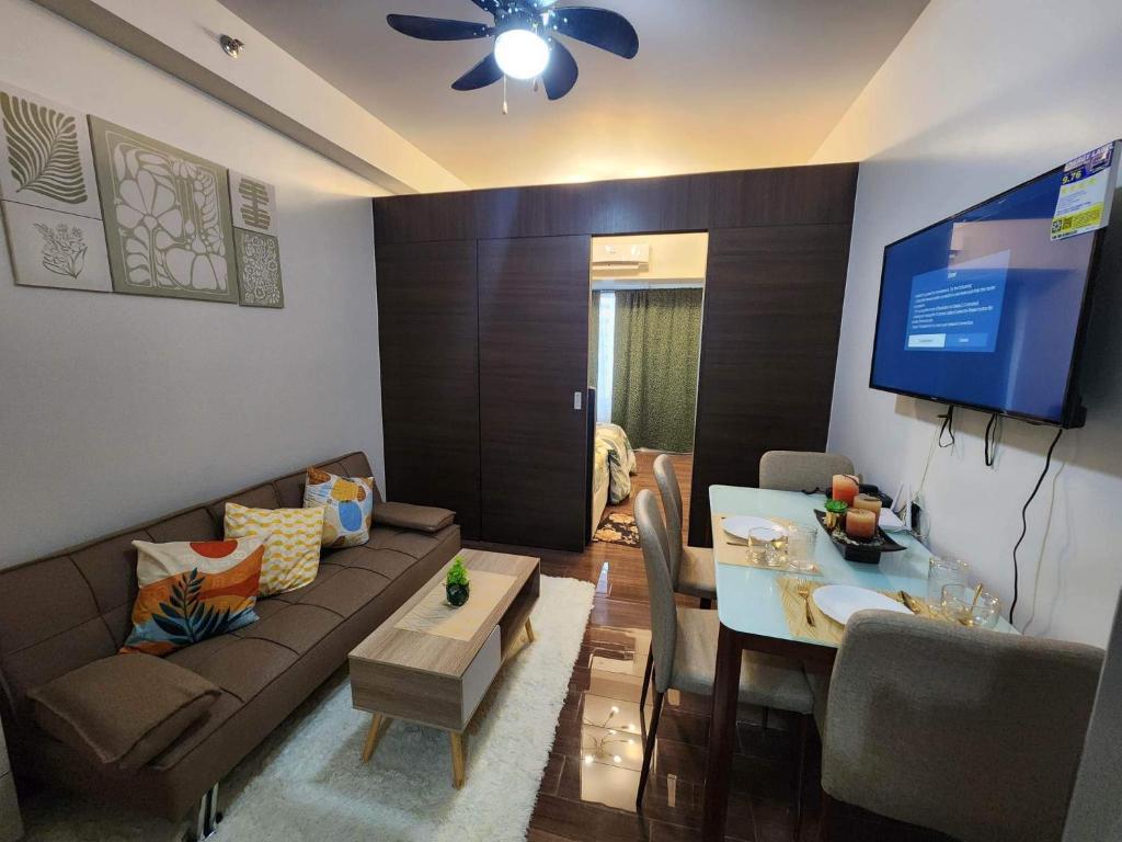 a living room with a couch and a table at air residences in Manila