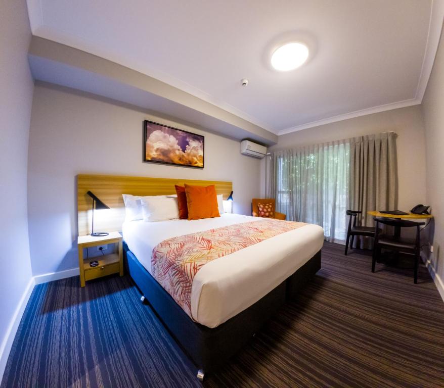 a hotel room with a bed and a desk at Potters Toowoomba Hotel in Toowoomba